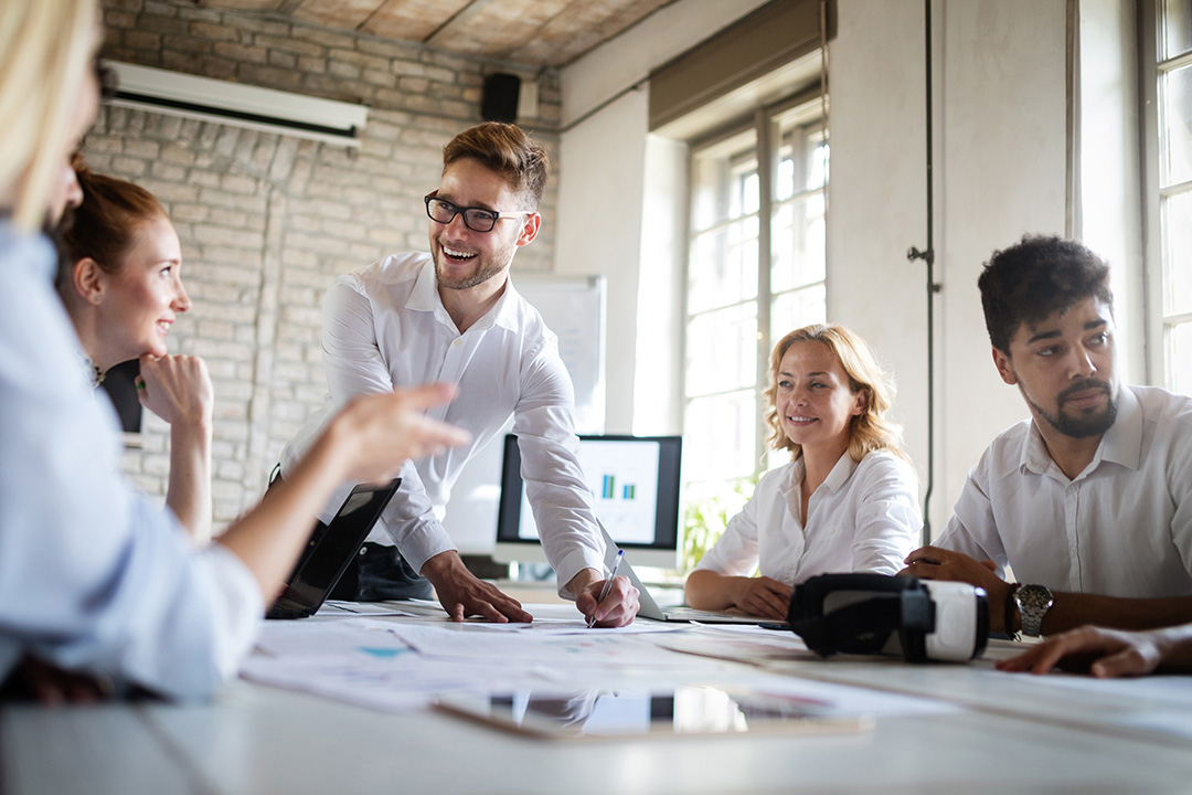 A marketing team in a board room strategizing on assembling a marketing plan